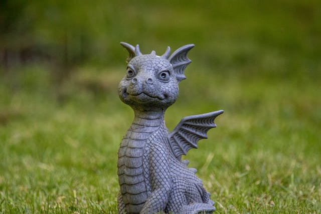Majestic dragon statue in commanding pose on office desk, symbolizing authority and career success