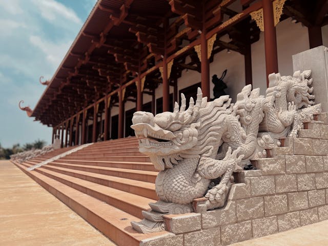 Complete collection of three dragon sculptures in wood, stone, and jade displayed together